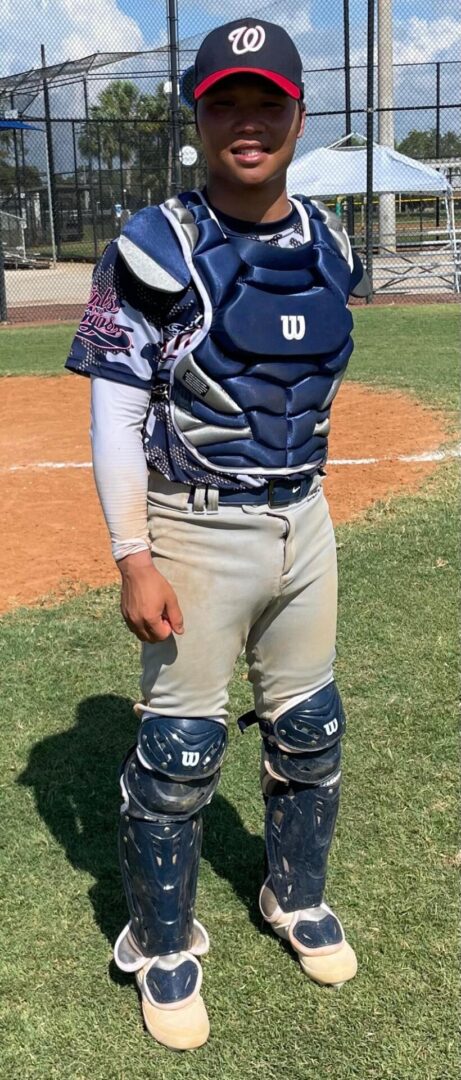 A baseball player in his catcher 's gear.