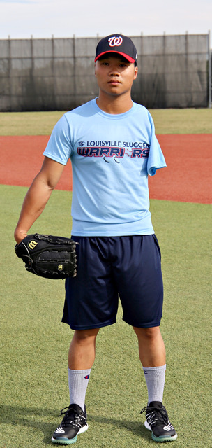 A man in blue shirt holding a baseball mitt.