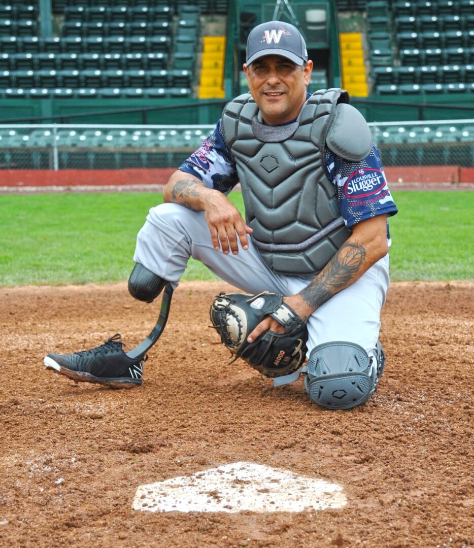 A baseball player kneeling down on the field